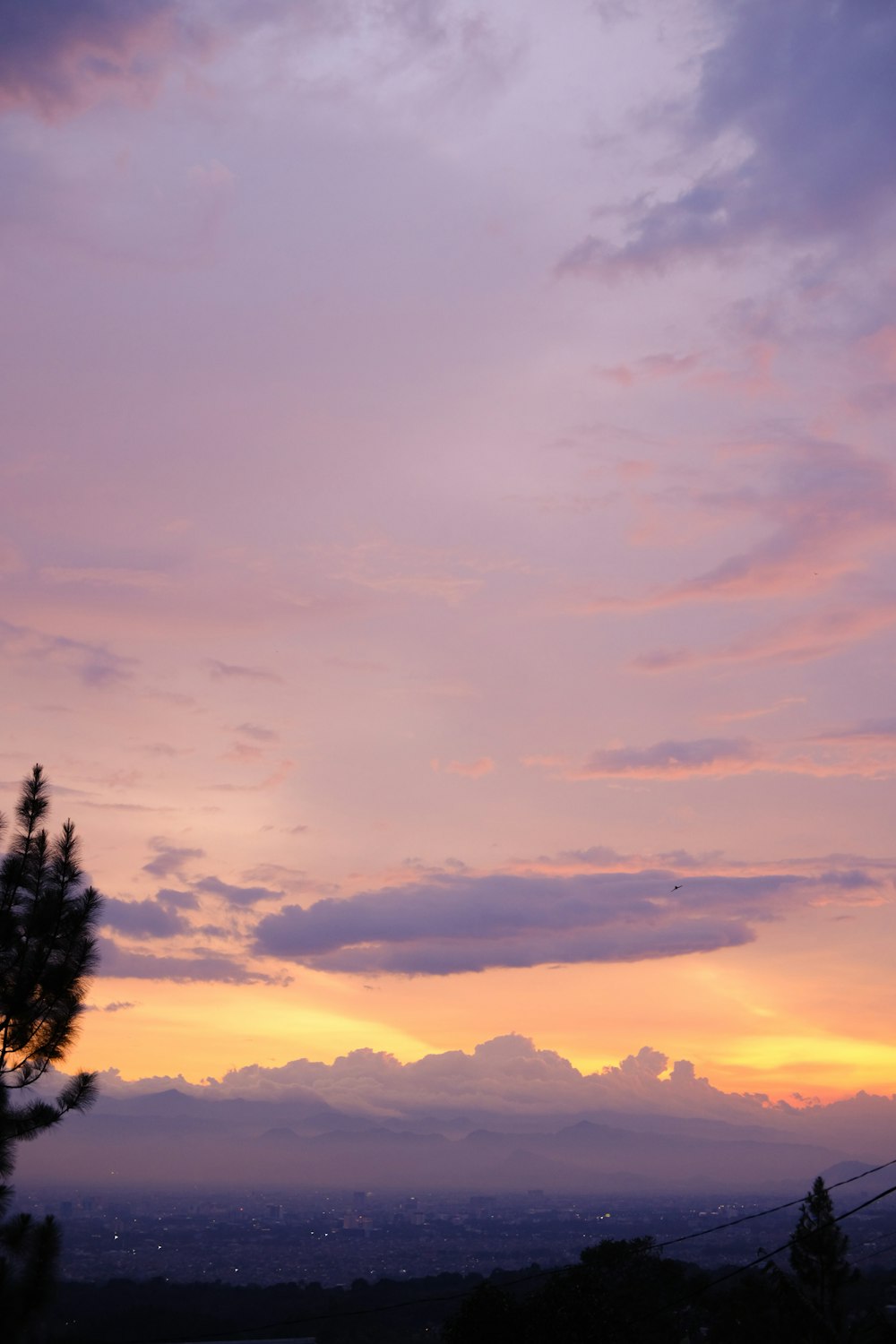 a view of a sunset from a hill top