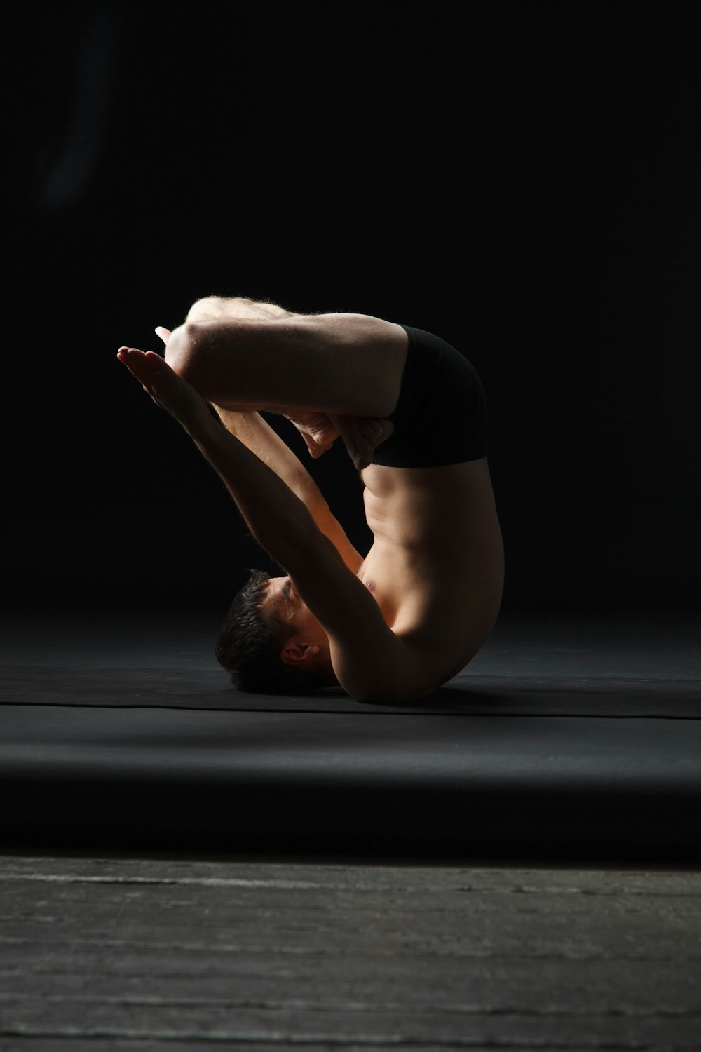 a man doing a handstand in the dark