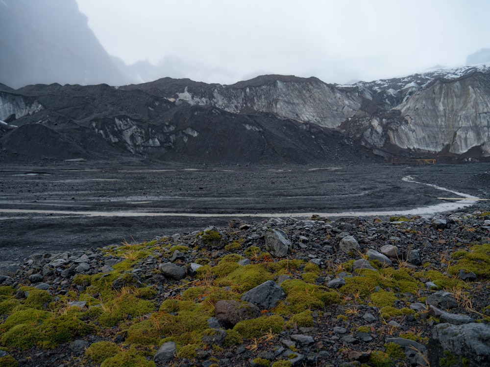 a rocky landscape with a river running through it