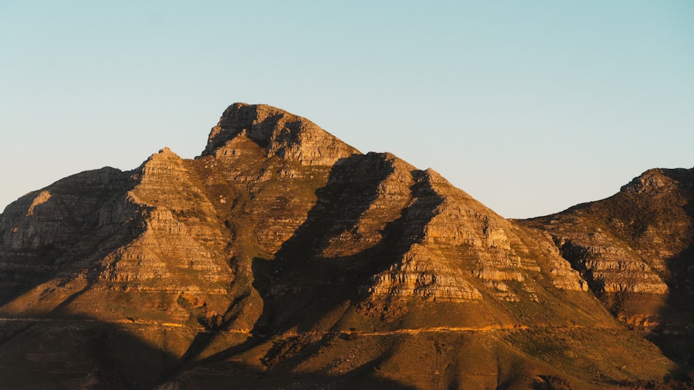 a very tall mountain with a sky in the background