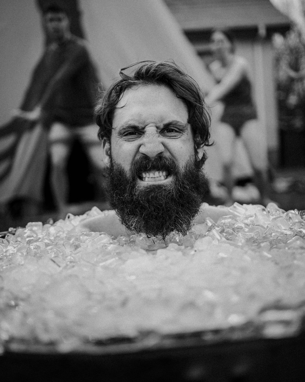 a man with a beard is in a tub of ice