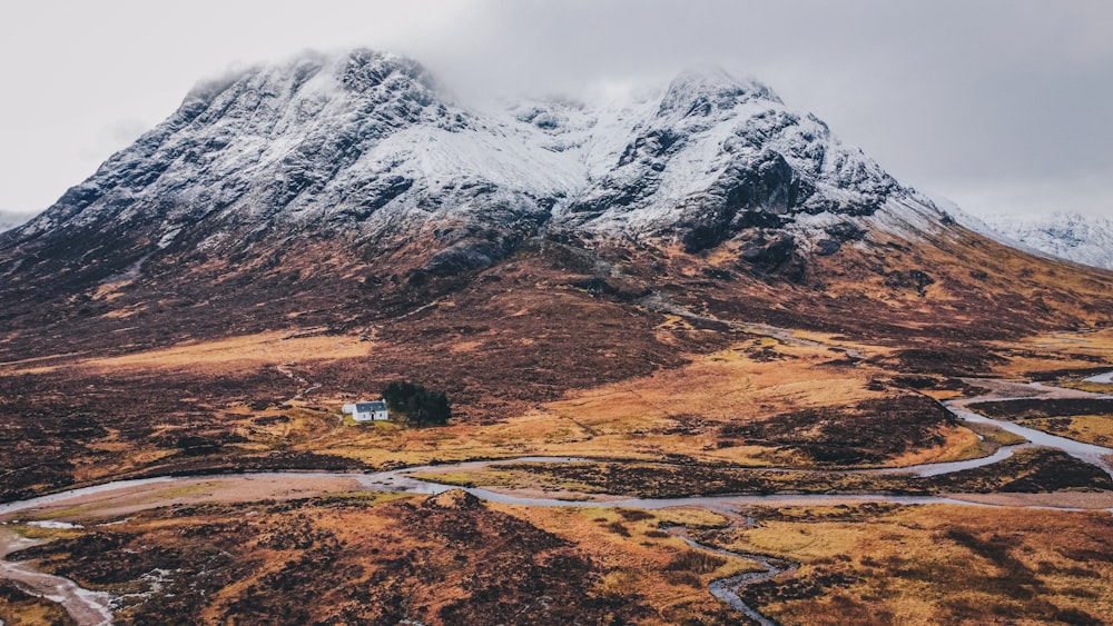 a mountain with a house in the middle of it