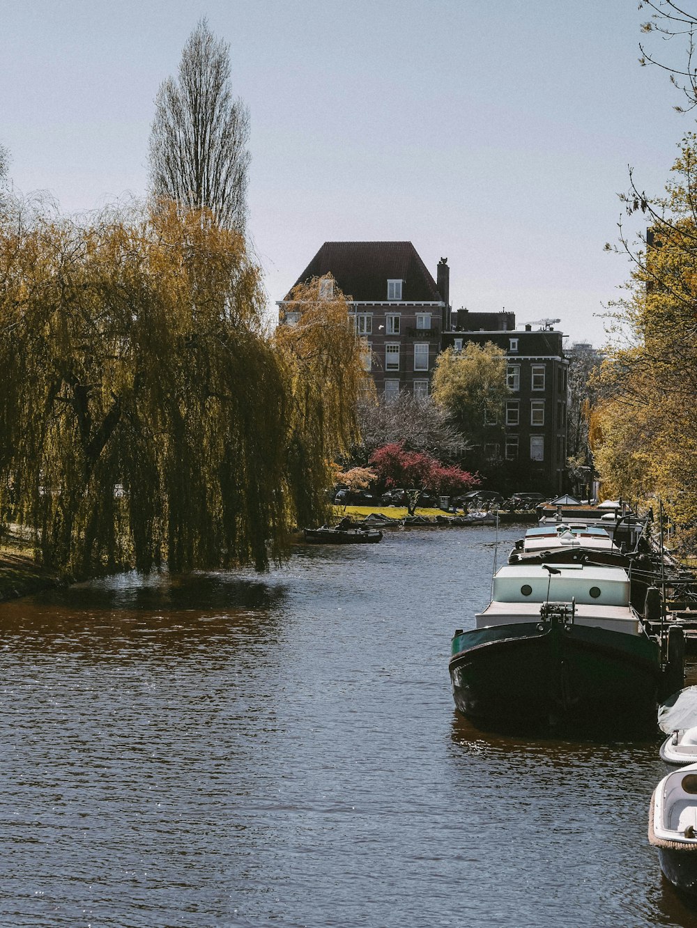 a row of boats sitting on top of a river