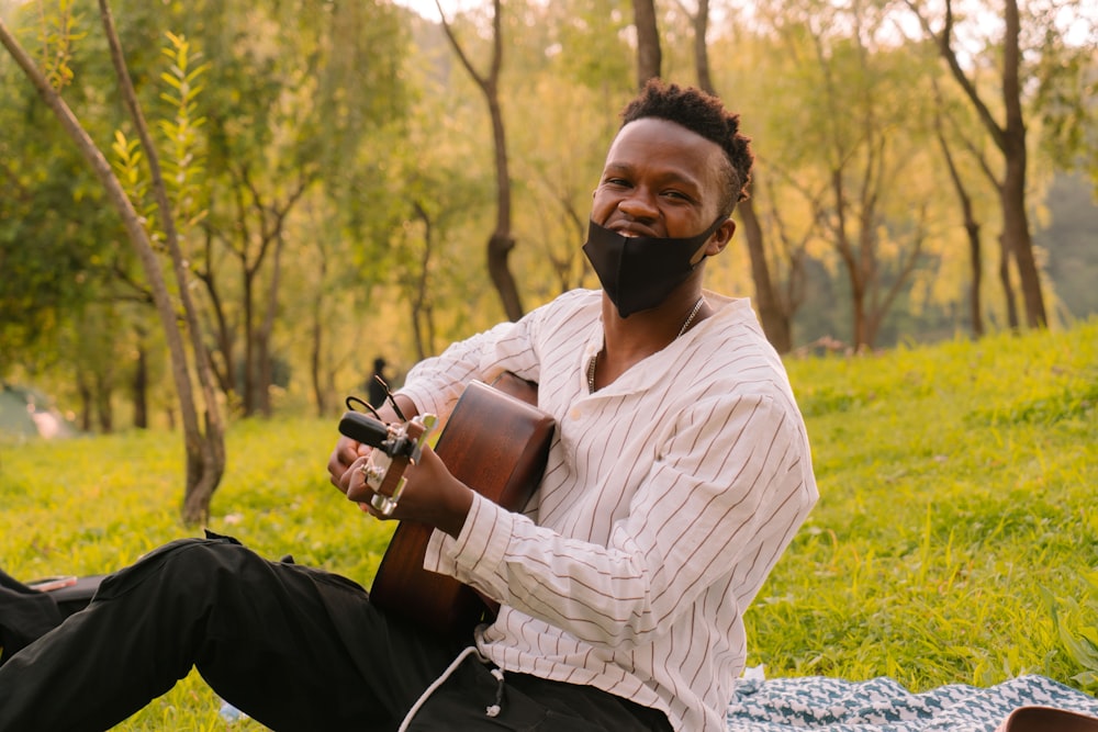 a man with a beard playing a guitar