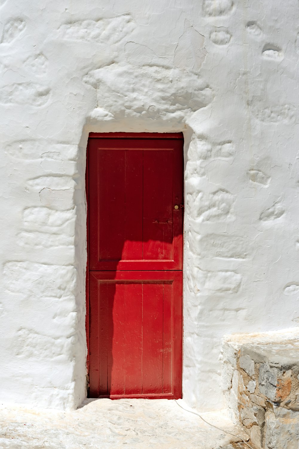 a red door is in a white wall