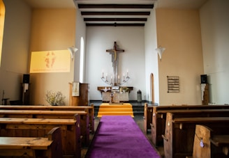 a church with pews and a cross on the wall