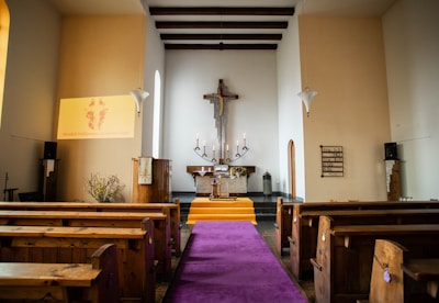 a church with pews and a cross on the wall