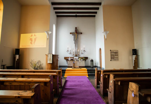 Quiet sanctuary with pews and a cross