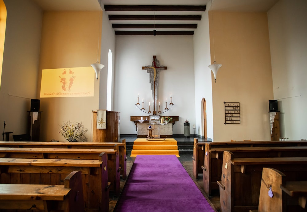 a church with pews and a cross on the wall