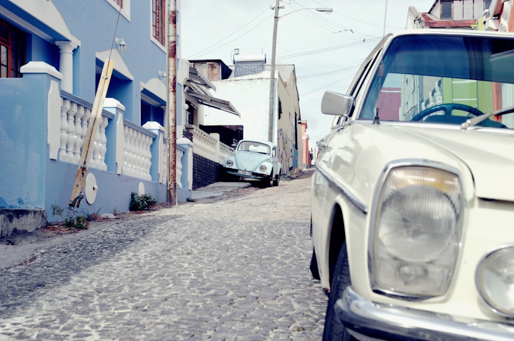 a white car parked on the side of a road