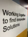 Black 3D text displays the phrase 'Working together to find innovative Solutions' against a geometric background with white, yellow, light blue, and dark blue areas.