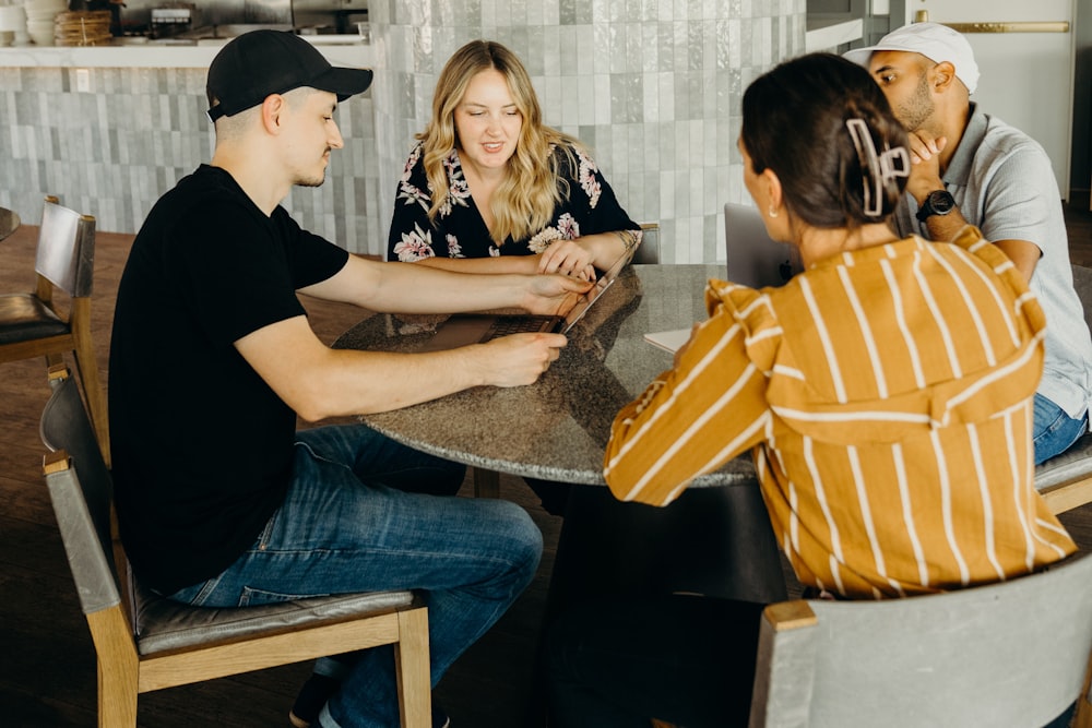 a group of people sitting around a table