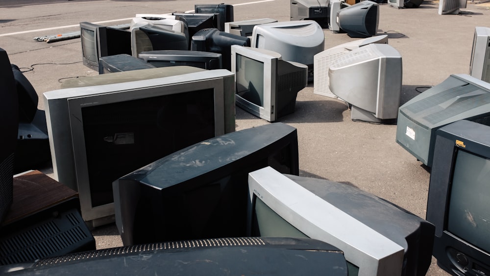 a bunch of old televisions sitting on the ground