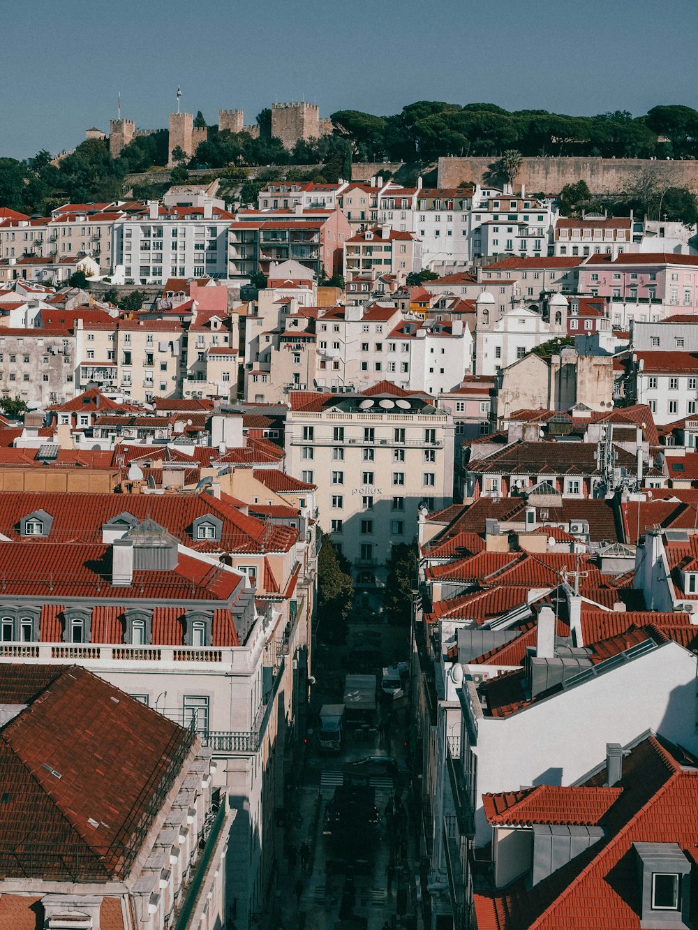 an aerial view of a city with red roofs