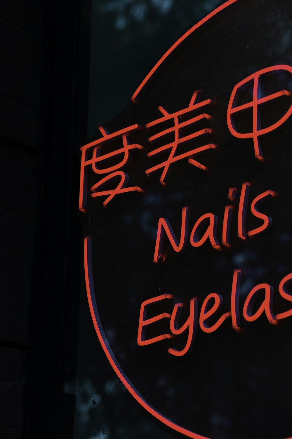 a neon sign that says nails and eyelashes