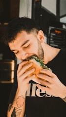 a man eating a sandwich in a restaurant