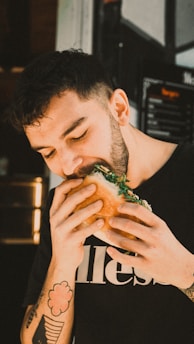 a man eating a sandwich in a restaurant