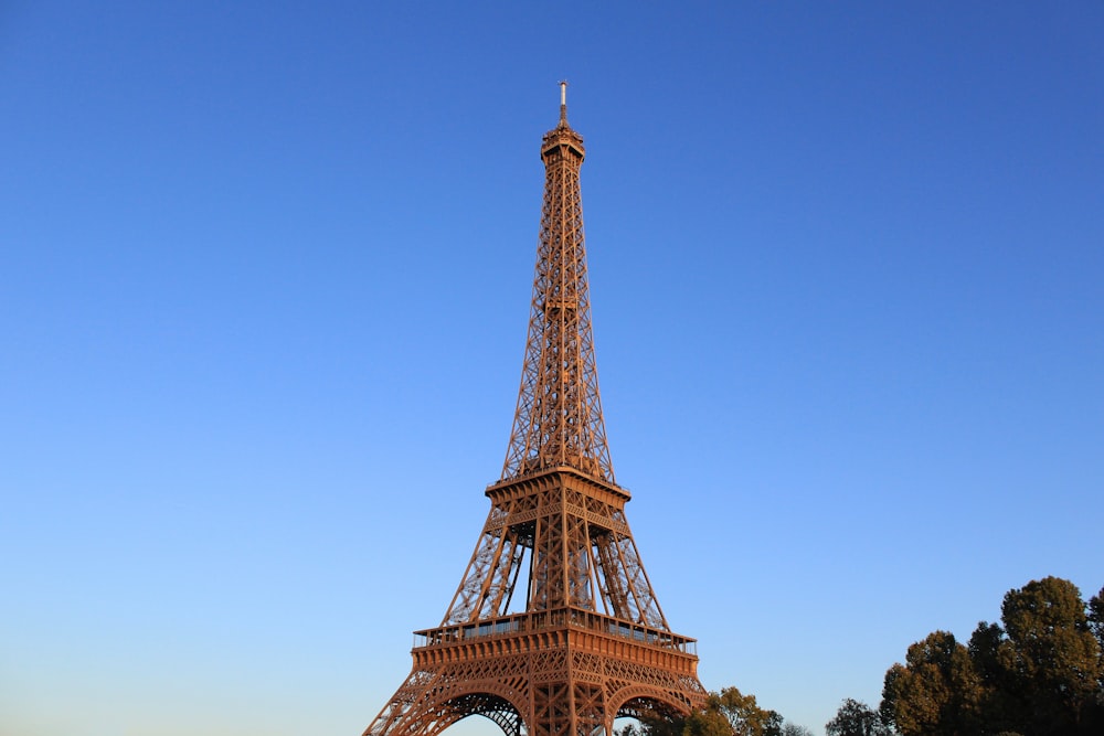 the eiffel tower stands tall against a blue sky