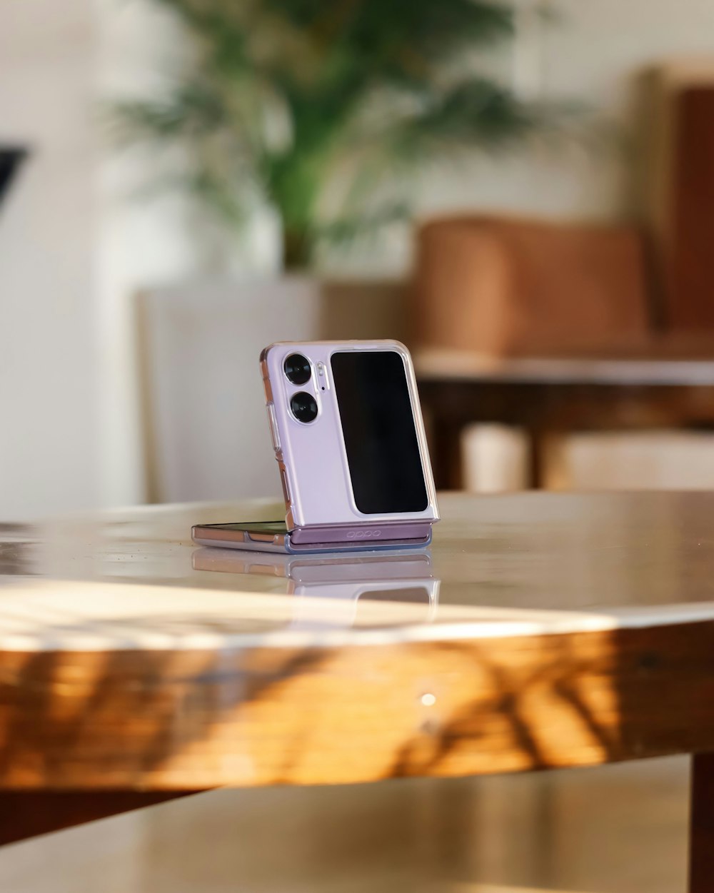 a cell phone sitting on top of a wooden table