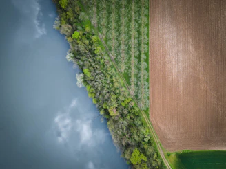 Aerial view of a flat land plot near a small river.