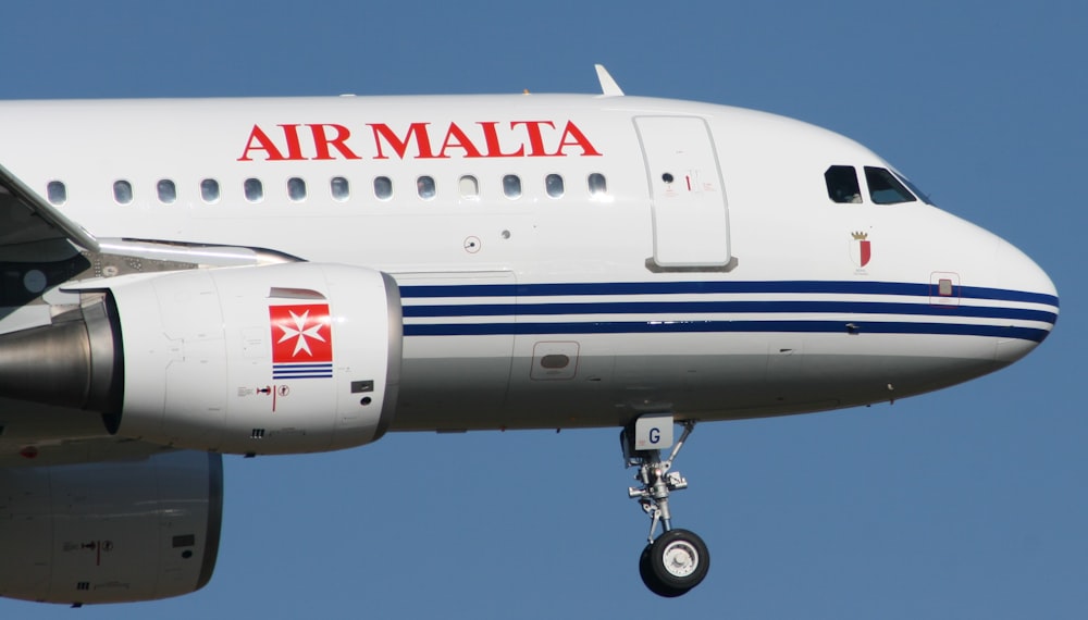 a large commercial airplane flying through a blue sky