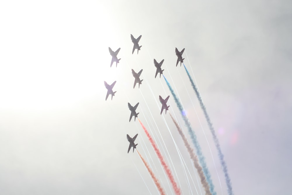 a group of jets flying through a cloudy sky