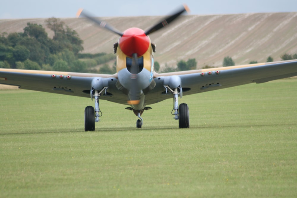 a small airplane sitting on top of a lush green field