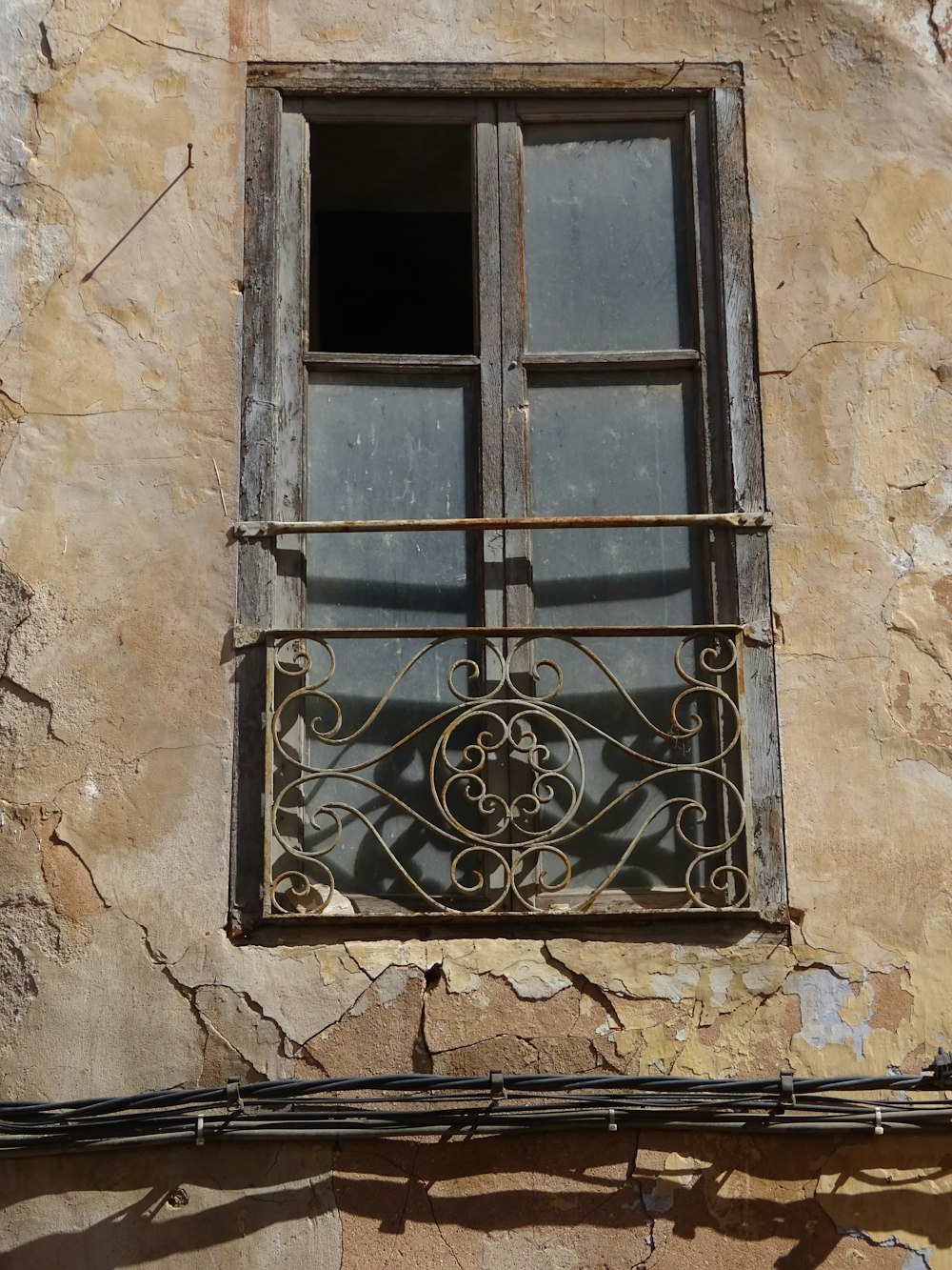a window on a building with iron bars