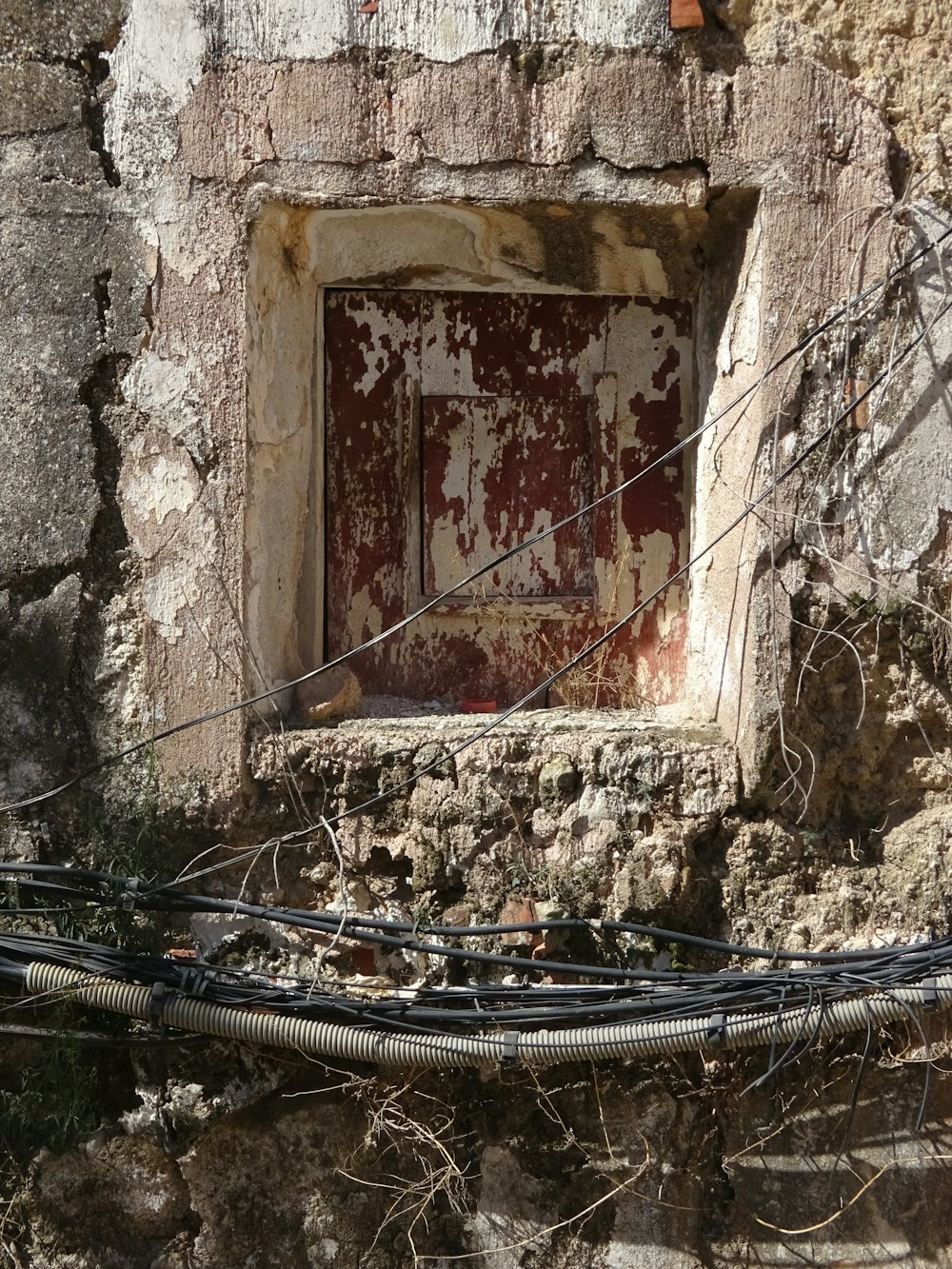 an old building with wires and a window