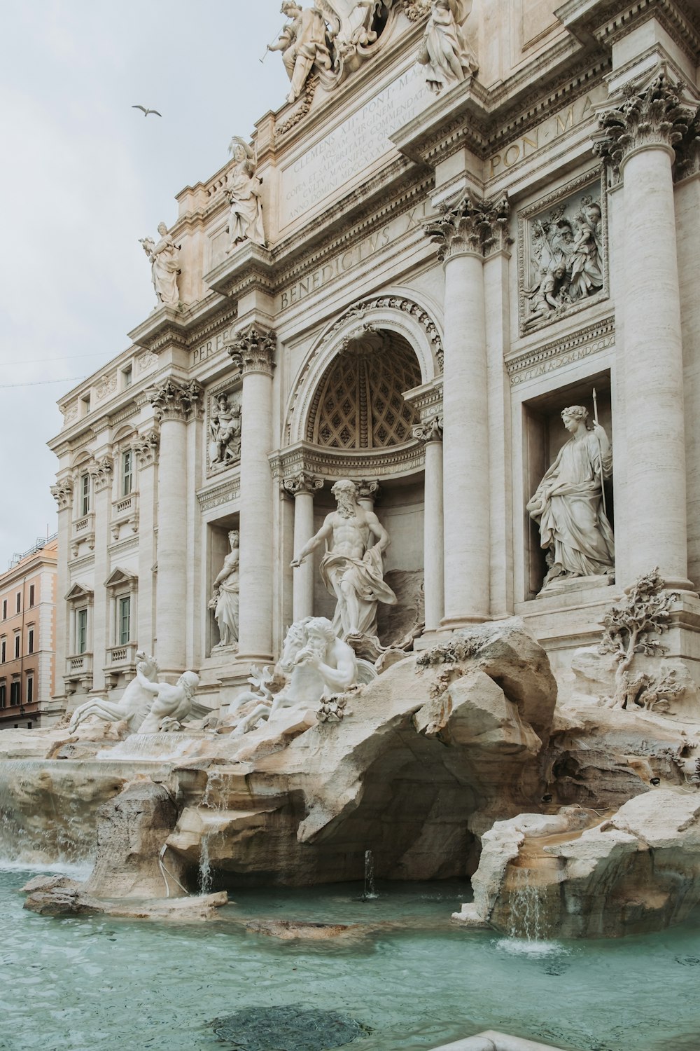 a large building with a fountain in front of it