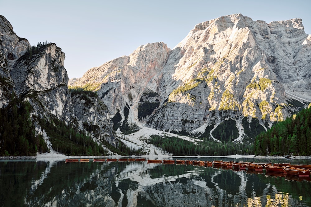 a mountain range is reflected in the still water of a lake