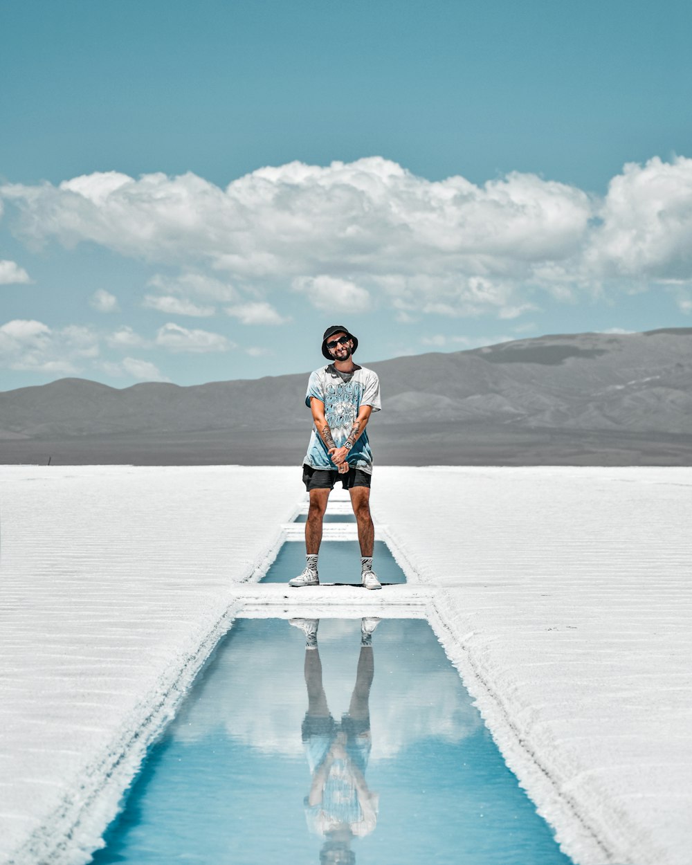 a man standing on top of a large pool of water