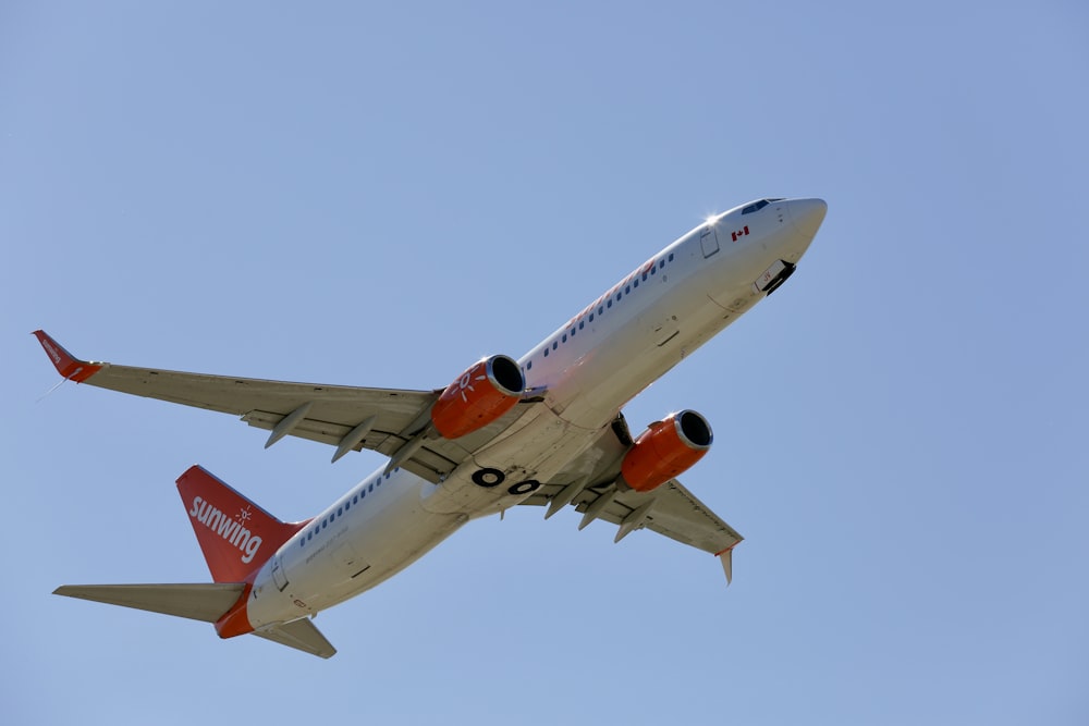 a large jetliner flying through a blue sky