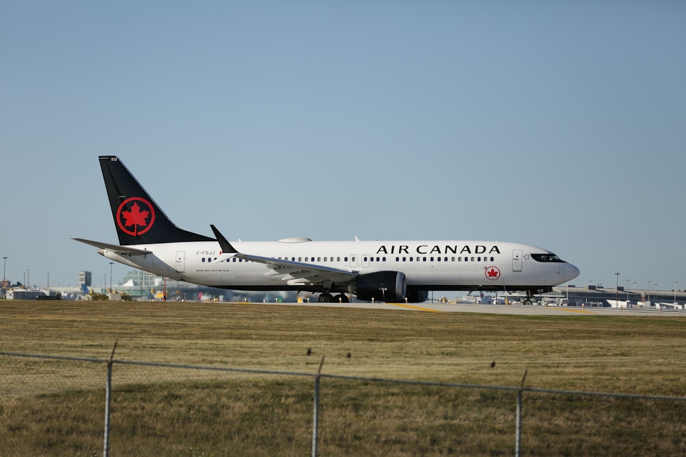 a large air canada airplane on a run way