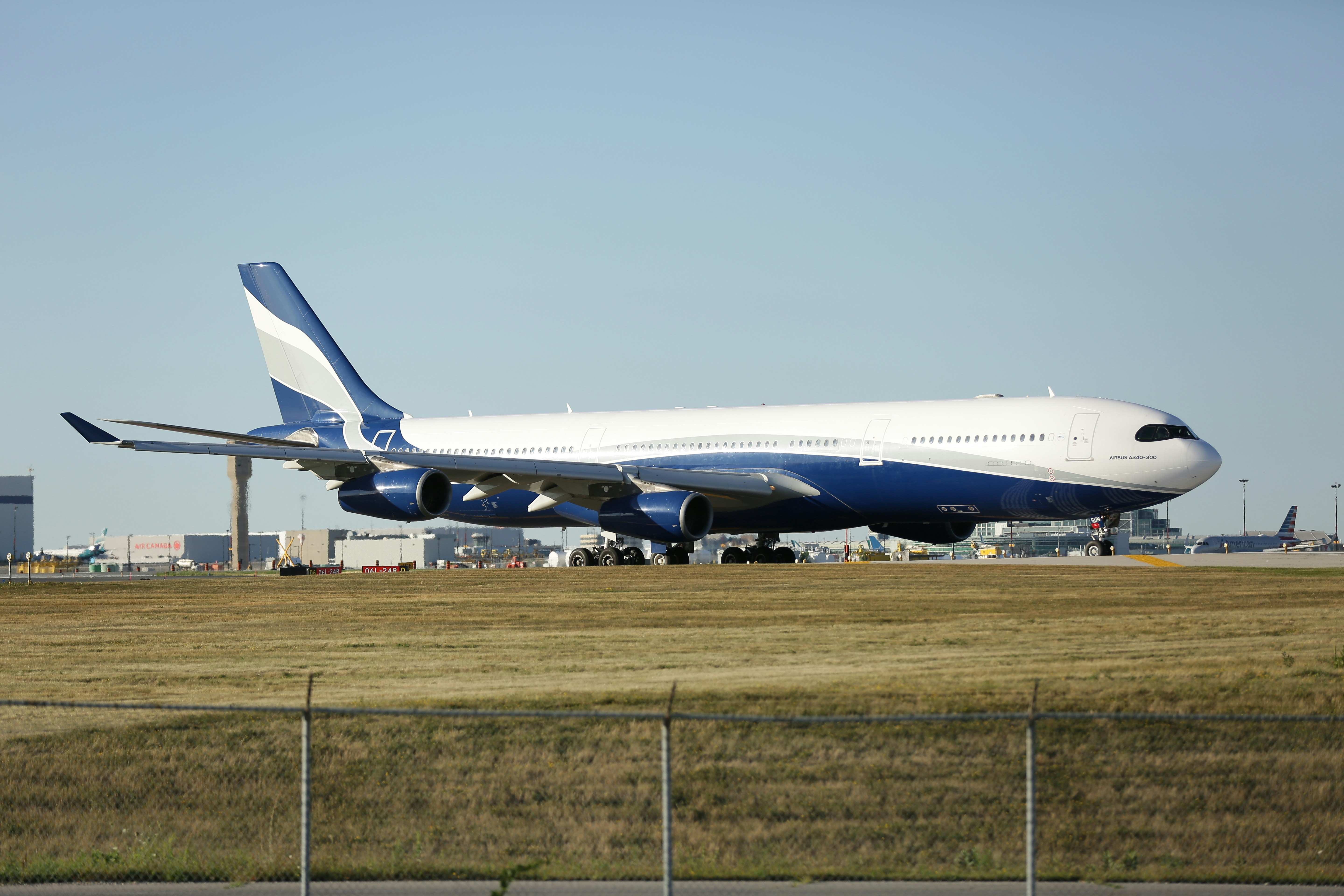a large jetliner sitting on top of an airport runway, 