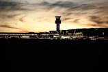 a view of an airport with a tower in the background