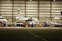 An instructor guiding trainees through aircraft maintenance procedures on a real plane.