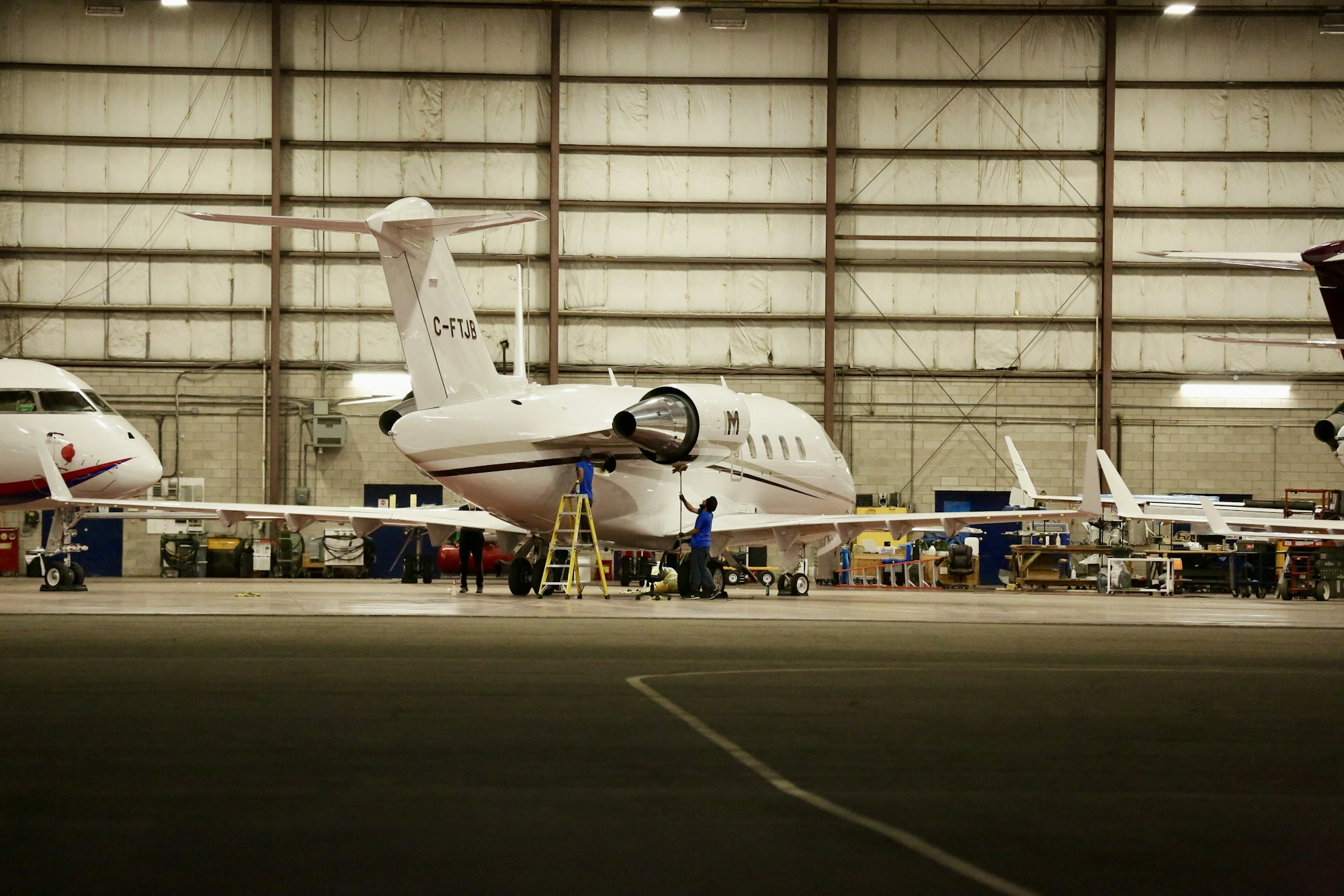 Business jets inside a maintenance hangar