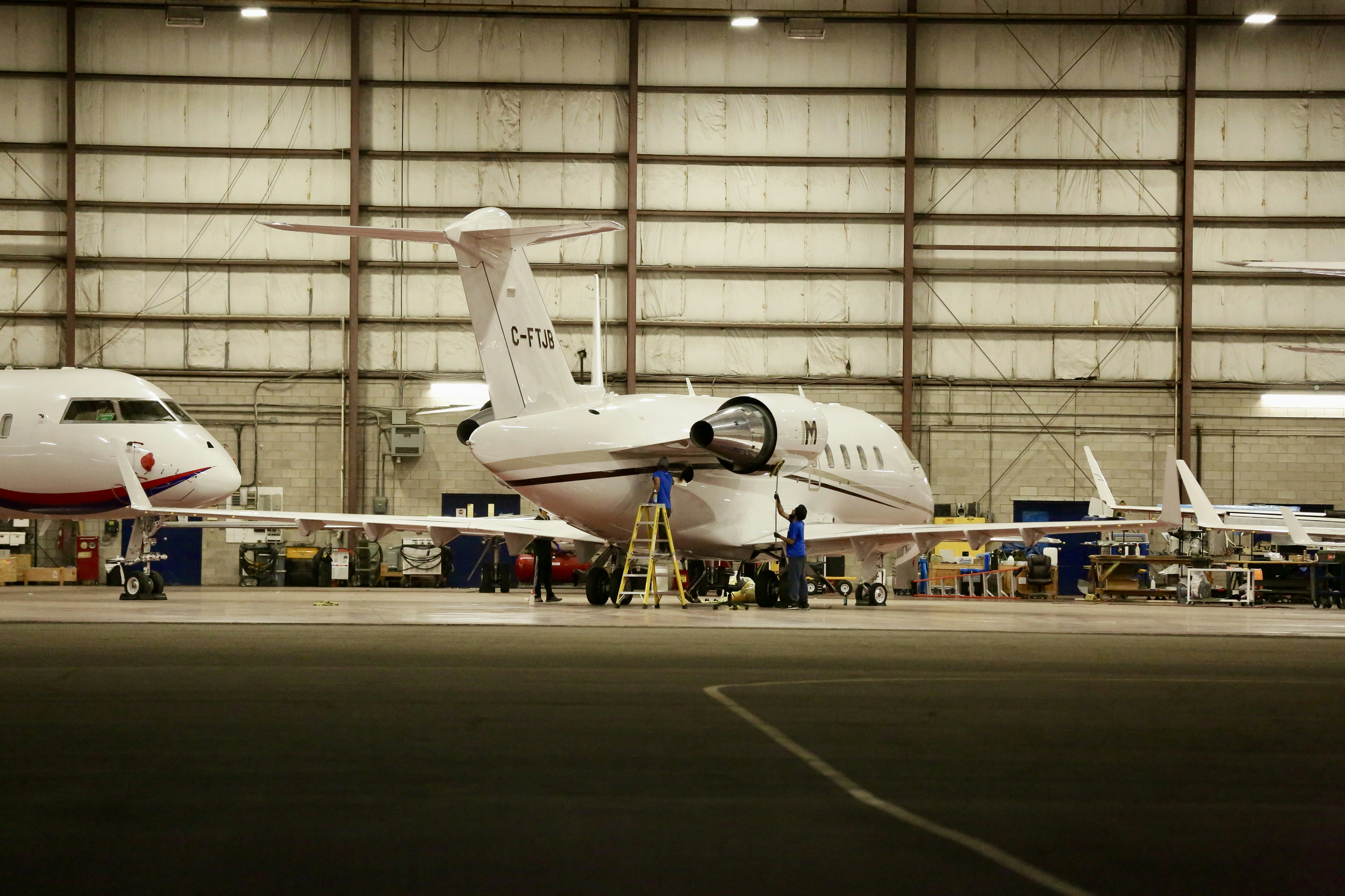 Boeing 737 aircraft engine maintenance inspection, dim hangar lighting, industrial atmosphere