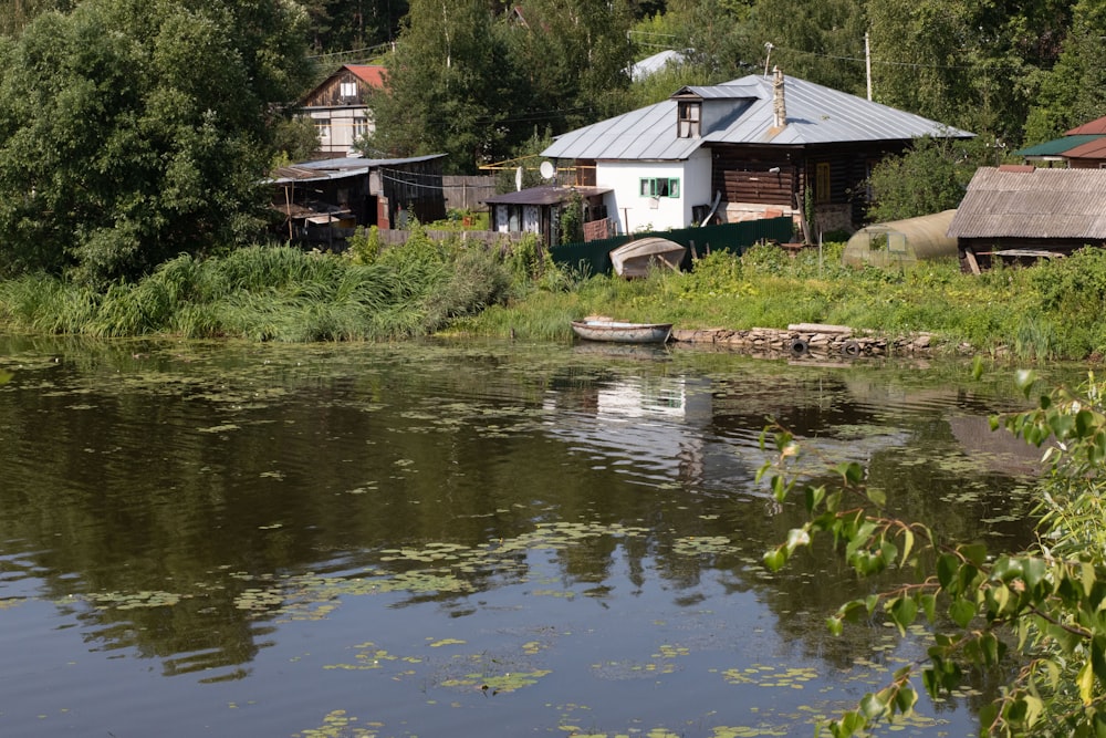 a small boat floating on top of a lake next to a forest