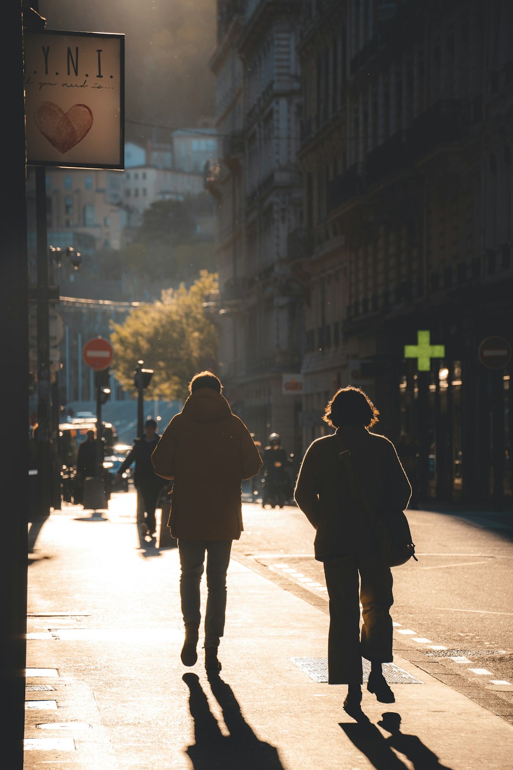 a couple of people walking down a street