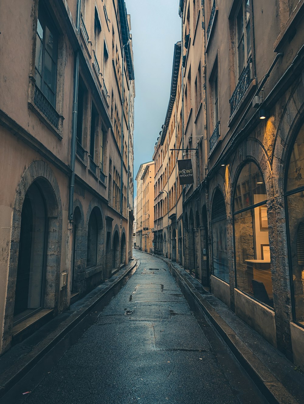 a narrow city street lined with tall buildings