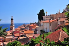a view of a village with a church tower in the background