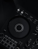 a close up of a dj controller on a black surface