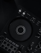 a close up of a dj controller on a black surface