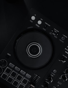 a close up of a dj controller on a black surface