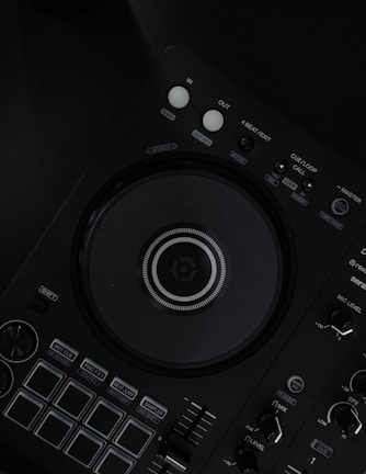 a close up of a dj controller on a black surface