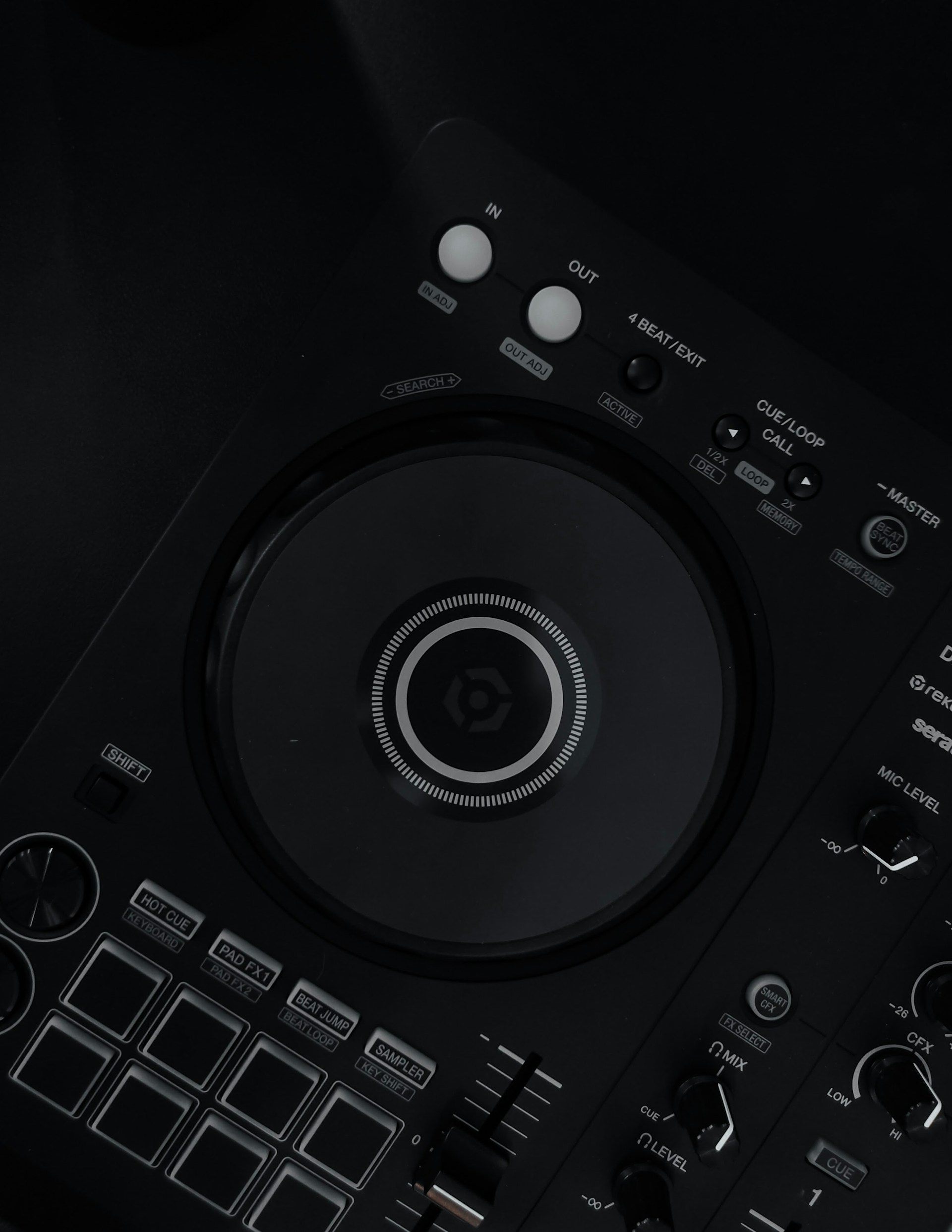 a close up of a dj controller on a black surface