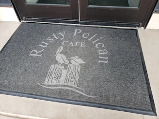 Durable custom mat placed at the entrance of a busy commercial building.