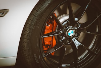 Close-up photo of a high-quality alloy wheel mounted on a sleek car.